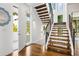 Bright entryway featuring hardwood floors and modern staircase with metal railing at 1260 Brook Forest Ne Dr, Atlanta, GA 30324