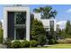 Modern home's facade with lush green landscaping against a bright blue sky at 1260 Brook Forest Ne Dr, Atlanta, GA 30324