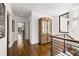 Upstairs hallway featuring modern railing and hardwood floors plus a cabinet at 1260 Brook Forest Ne Dr, Atlanta, GA 30324