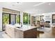 Open concept kitchen with large island and view of the living area and pool at 1260 Brook Forest Ne Dr, Atlanta, GA 30324
