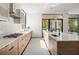 Modern kitchen with stainless steel appliances, light wood cabinets, and a large window at 1260 Brook Forest Ne Dr, Atlanta, GA 30324