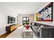 Stylish living room with a plush gray sofa, modern art, and sleek entertainment center at 1260 Brook Forest Ne Dr, Atlanta, GA 30324