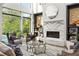 Sun-drenched living room with fireplace, built-in shelves, and large windows at 1260 Brook Forest Ne Dr, Atlanta, GA 30324