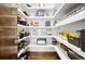 Walk-in pantry features white shelving and hardwood flooring at 1260 Brook Forest Ne Dr, Atlanta, GA 30324