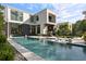 Stunning modern home featuring a luxurious backyard pool with in-pool loungers and stylish outdoor living space at 1260 Brook Forest Ne Dr, Atlanta, GA 30324