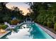 Serene backyard pool with lounge chairs, a covered seating area, and lush greenery, creating a tranquil oasis at 1260 Brook Forest Ne Dr, Atlanta, GA 30324