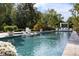 Beautiful backyard pool surrounded by lush landscaping and a covered lounge area, perfect for relaxation at 1260 Brook Forest Ne Dr, Atlanta, GA 30324