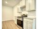 Kitchen showing stainless steel appliances, countertops and cabinets at 700 Park Place Way, Social Circle, GA 30025