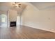Living room with a fireplace, vaulted ceilings, and an archway into another room at 700 Park Place Way, Social Circle, GA 30025