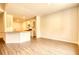 Open floor plan with a kitchen, dining area, and living space under warm lighting at 700 Park Place Way, Social Circle, GA 30025