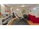 Basement with gym equipment, red sofa, and white brick wall at 1122 Springdale Ne Rd, Atlanta, GA 30306