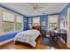 Bright blue bedroom featuring hardwood floors, lots of natural light, and a study area at 1122 Springdale Ne Rd, Atlanta, GA 30306