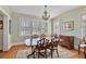 Bright dining room with large windows, chandelier, hardwood floors, and a dining table with six chairs at 1122 Springdale Ne Rd, Atlanta, GA 30306