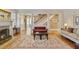 Comfortable living room featuring a fireplace, hardwood floors, area rug, and view of the stairs at 1122 Springdale Ne Rd, Atlanta, GA 30306