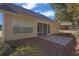 A screened-in porch and patio in a serene backyard setting, with a glimpse of neighboring properties at 1150 Strath Clyde Way, Mcdonough, GA 30253