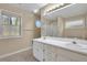 Bright bathroom with double vanity, large mirror, and a separate shower and soaking tub at 1150 Strath Clyde Way, Mcdonough, GA 30253