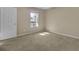 Bedroom featuring neutral walls, plush carpet, and a window allowing natural light at 1150 Strath Clyde Way, Mcdonough, GA 30253