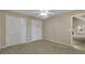 A cozy bedroom featuring neutral walls, a ceiling fan, and a double closet for ample storage at 1150 Strath Clyde Way, Mcdonough, GA 30253