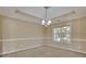 Cozy dining room with a modern chandelier and a large window overlooking the landscaped yard at 1150 Strath Clyde Way, Mcdonough, GA 30253