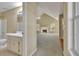 Hallway view of the bathroom and the living room with vaulted ceilings, fireplace, and lots of windows at 1150 Strath Clyde Way, Mcdonough, GA 30253