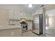 Bright kitchen featuring white cabinets, stainless steel appliances, and an open layout at 1150 Strath Clyde Way, Mcdonough, GA 30253