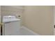 Functional laundry room featuring a washer, dryer, and ample shelving for storage solutions at 1150 Strath Clyde Way, Mcdonough, GA 30253