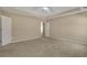 Large main bedroom with plush carpet, tray ceiling, and access to a walk-in closet and a private bathroom at 1150 Strath Clyde Way, Mcdonough, GA 30253