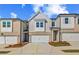 Newly constructed townhome showcasing a one-car garage and attractive curb appeal at 308 Shine Dr, Stockbridge, GA 30281