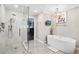 Bright bathroom with walk-in shower, a soaking tub, a TV, and decorative pig art at 501 Brook Hollow Se Cir, Marietta, GA 30067