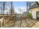 Wooden deck with shadow accents overlooking the surrounding landscape and offering outdoor enjoyment at 501 Brook Hollow Se Cir, Marietta, GA 30067