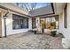 Inviting front porch with brick flooring, rocking chairs, and large windows for natural light at 501 Brook Hollow Se Cir, Marietta, GA 30067