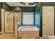 En-suite bathroom showcasing a soaking tub, glass-enclosed shower, and decorative wallpaper at 1225 Sand Knoll Sw Run, Lilburn, GA 30047