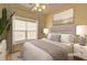 Cozy bedroom with large window, neutral tones, and stylish decor at 1225 Sand Knoll Sw Run, Lilburn, GA 30047