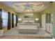 Serene primary bedroom featuring a tray ceiling, large windows, and soft neutral tones at 1225 Sand Knoll Sw Run, Lilburn, GA 30047