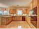 Spacious kitchen featuring wooden cabinets, granite countertops, and modern appliances at 1225 Sand Knoll Sw Run, Lilburn, GA 30047