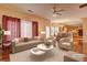 An open-concept living area with ample seating, flowing into dining and kitchen at 1225 Sand Knoll Sw Run, Lilburn, GA 30047