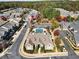 Aerial view of townhome community clubhouse with swimming pool and vibrant fall foliage at 1350 Bluestone Dr, Cumming, GA 30041