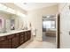 Bright bathroom with double sinks, granite countertops, and access to the main bedroom at 1350 Bluestone Dr, Cumming, GA 30041