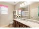 A well-lit bathroom features a vanity with granite countertops and a patterned shower curtain at 1350 Bluestone Dr, Cumming, GA 30041