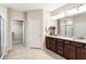 A spacious bathroom features a double sink vanity with granite countertops and a walk-in closet at 1350 Bluestone Dr, Cumming, GA 30041