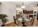 Cozy dining area with glass top table, views to the kitchen, and warm natural lighting at 1350 Bluestone Dr, Cumming, GA 30041