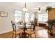 Inviting dining area with hardwood floors, bright windows, and contemporary chandelier at 1350 Bluestone Dr, Cumming, GA 30041