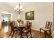 Cozy dining room with wood floors, area rug, chandelier, and bright natural light at 1350 Bluestone Dr, Cumming, GA 30041