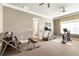 Well-equipped fitness center with treadmill, stationary bike, weights and an exercise bench at 1350 Bluestone Dr, Cumming, GA 30041