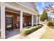 Inviting front porch with brick accents, supportive pillars, and seating area at 1350 Bluestone Dr, Cumming, GA 30041