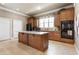 Spacious kitchen with an island, granite countertops, and wood cabinetry at 1350 Bluestone Dr, Cumming, GA 30041