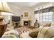 Comfortable living room showcasing fireplace, hardwood floors, and bright windows at 1350 Bluestone Dr, Cumming, GA 30041