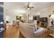 Open-concept living room featuring hardwood floors, neutral decor, and seamless flow to dining area at 1350 Bluestone Dr, Cumming, GA 30041