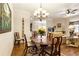 Open-concept living space with dining area, living room with fireplace, and hardwood floors at 1350 Bluestone Dr, Cumming, GA 30041