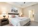 Calm bedroom featuring tray ceiling, neutral decor, and an ensuite bathroom at 1350 Bluestone Dr, Cumming, GA 30041